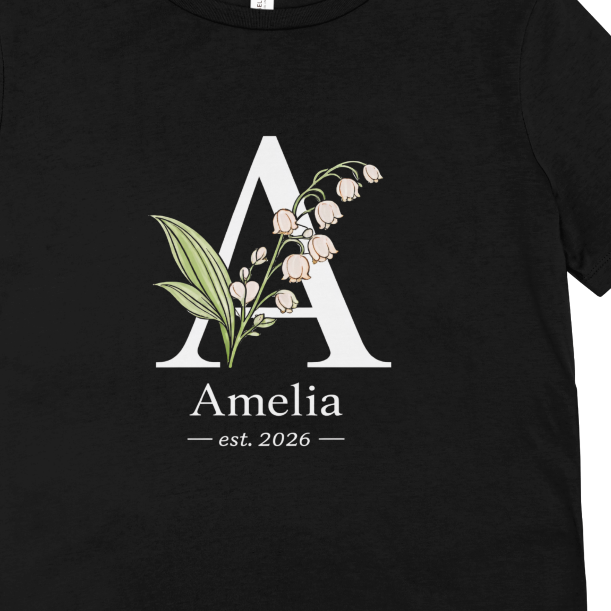 Black t-shirt close-up floral initial letter and name detail